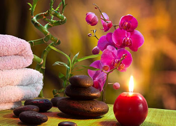 composition spa massage - bamboo - orchid, towels, candles and black stones-vertical